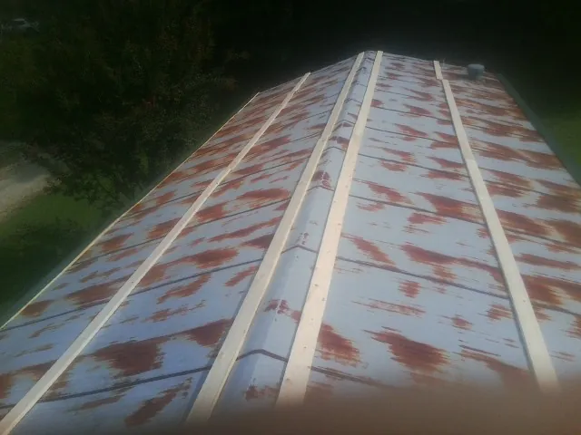 Rusted metal roof panels with new wood purlins before replacement — Storm Damage Roof Repair in Mesa by Roofing Brothers